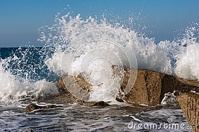 Wave Smashing Rocks Stock Photo