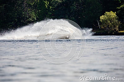 Wave and splash of water is covering the entire jet ski that is making it Editorial Stock Photo