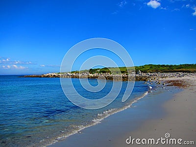 A wave washes onshore at a beach Stock Photo