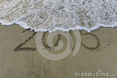 Wave wipe 2015 drawing on sand Stock Photo