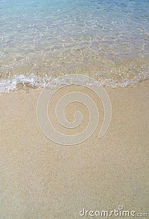 Waves against the sandy beach a beautiful summer day Stock Photo