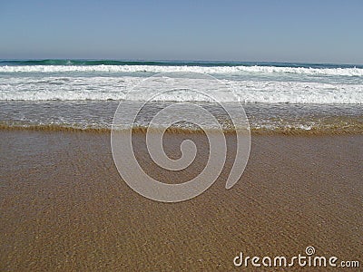 The waves approach the beach calmly Stock Photo