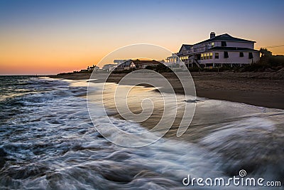 Waves in the Atlantic Ocean and beachfront homes at sunset, Edisto Beach, South Carolina. Stock Photo