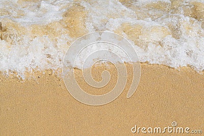 Close-up of foamy waves breaking on a beach Stock Photo