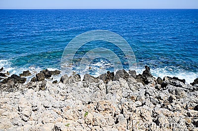 Waves beat against the rocky shore Stock Photo