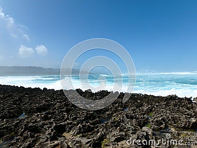 Waves Break on Coral Rock Shore Stock Photo