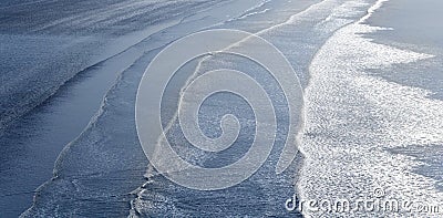 Waves breaking on beach Stock Photo