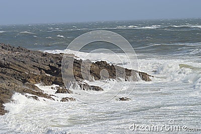 Waves breaking over rocks near Mumbles, Wales, UK Stock Photo