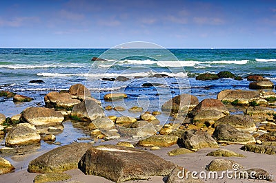 Waves breaking on rocky beach Stock Photo