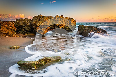 Waves and coral at sunrise in the Atlantic Ocean at Coral Cove P Stock Photo