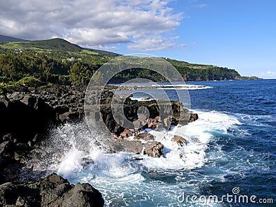 Waves crashing against basaltic rocks in Vincendo, Saint Joseph, Reunion Stock Photo