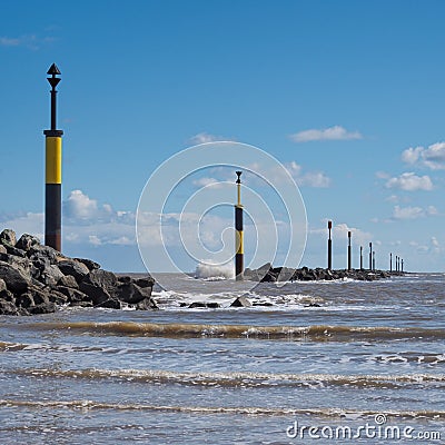 Waves crashing against breakwater at entrance to bay, Sea Palling, Norfolk Stock Photo