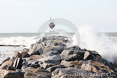 Waves crashing on jetty rocks Stock Photo