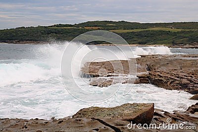 Waves Crashing Over Jagged rocks Stock Photo