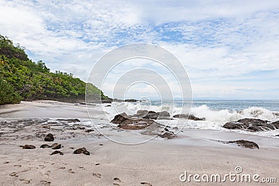 Waves crashing to rocks montezuma beach Stock Photo