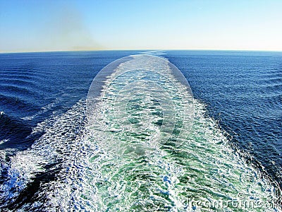 Waves and exhaust gases from a ship Stock Photo