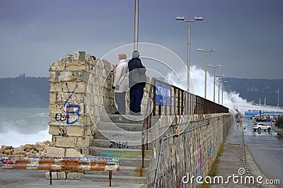 Waves flooding breakwater and cars Editorial Stock Photo