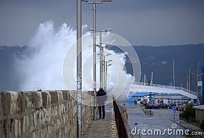 Waves flooding breakwater thrill seekers Editorial Stock Photo