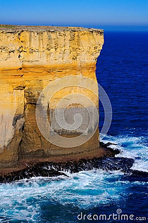 Waves hitting steep cliff wall Stock Photo