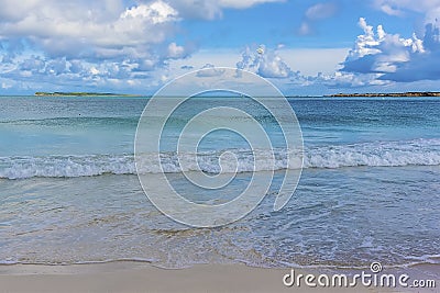 Waves lap the shoreline on Orient Beach in St Martin Stock Photo