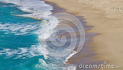 Waves lapping onto a sandy beach - image Stock Photo