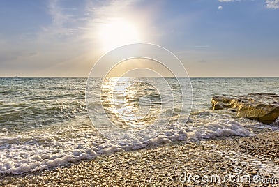 Waves lapping on the pebble beach Stock Photo