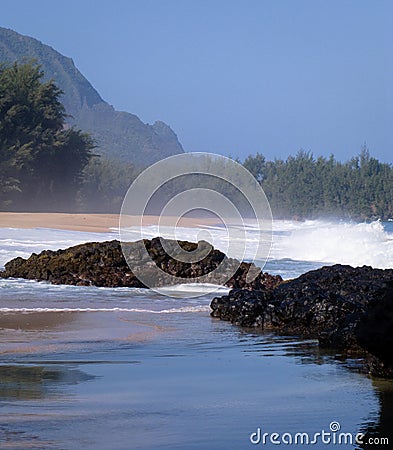 Waves over rocks on Lumahai Stock Photo