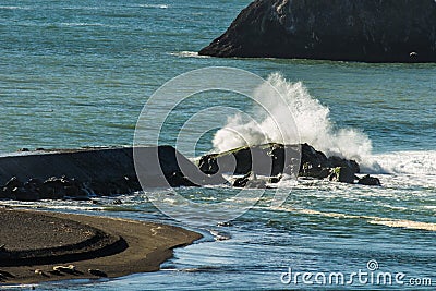 Waves from the Pacific Ocean breaking over the break water on the Russian River Stock Photo