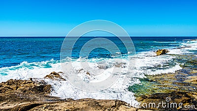 Waves of the Pacific Ocean crashing on the rocks on the shoreline of Ko Olina on the island of Oahu Stock Photo