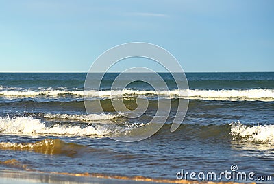 Waves at sea. Waves at sea during storm and wind. Wave from the sea goes on land to the beach. Stock Photo