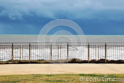 Waves Seen through Stainless Steel Fence Stock Photo