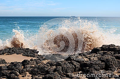 Waves splashing on basalt rocks at Ocean beach Bunbury Western Australia Stock Photo