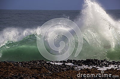 Waves splashing on basalt rocks at Ocean beach Bunbury Western Australia Stock Photo