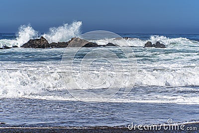 Waves splashing on huge rocks, off shore, Stock Photo