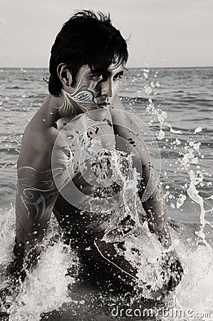 Waves splashing on male model Stock Photo