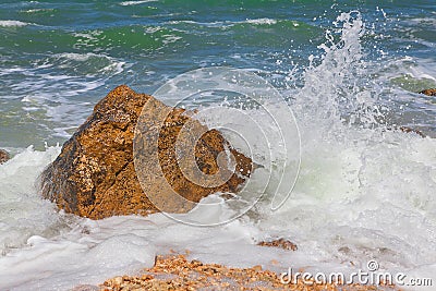 Waves splashing rock Stock Photo