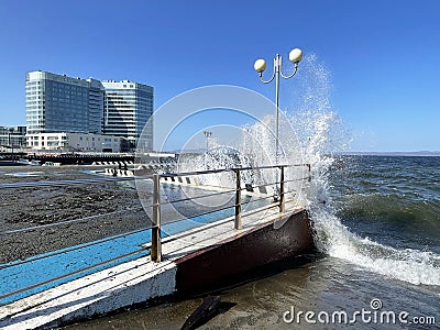 Vladivostok, Russia, October, 10, 2023. Waves on the Sports embankment against the background of the Barny apart-hotel Editorial Stock Photo