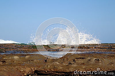 Waves and surf Crashing over rocks Stock Photo