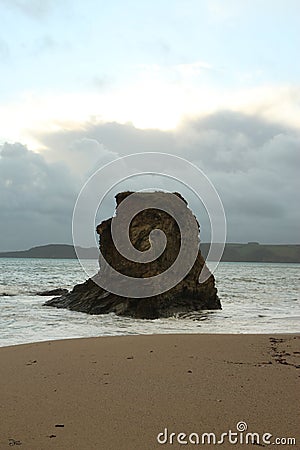 Waves sweeping against the rocks and sand of Carlyon bay in South Cornwall Stock Photo