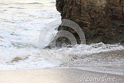 Waves sweeping against the rocks and sand of Carlyon bay in South Cornwall Stock Photo
