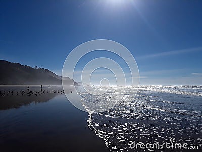 Waves washing up on the beach in Half Moon Bay California Stock Photo