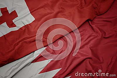 waving colorful flag of bahrain and national flag of Tonga Stock Photo