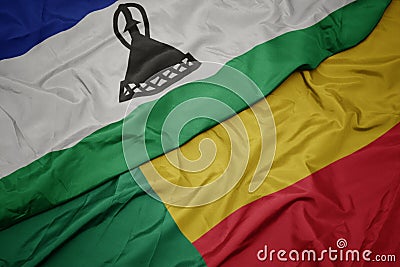 waving colorful flag of benin and national flag of lesotho Stock Photo