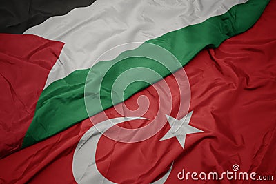 waving colorful flag of turkey and national flag of palestine Stock Photo