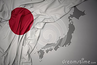Waving colorful national flag and map of japan. Stock Photo