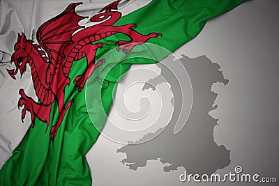 Waving colorful national flag and map of wales. Stock Photo