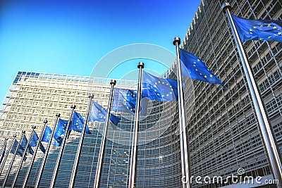 Waving EU flags in front of European Commission in Brussels Stock Photo