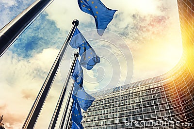 Waving EU flags in front of European Commission in Brussels Stock Photo