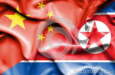 Waving flag of North Korea and China Stock Photo