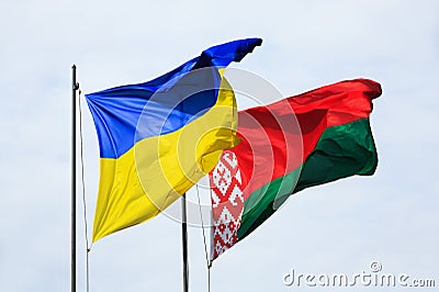Waving flags of Ukraine and Belarus Stock Photo